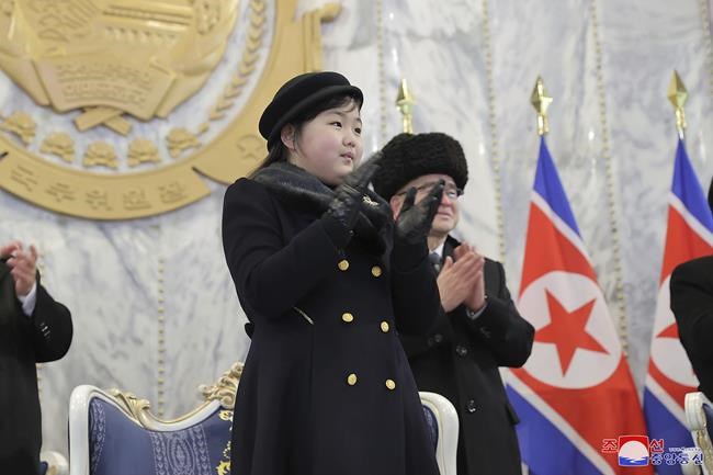 Kim Jong Un displays daughter and rockets in large parade 21